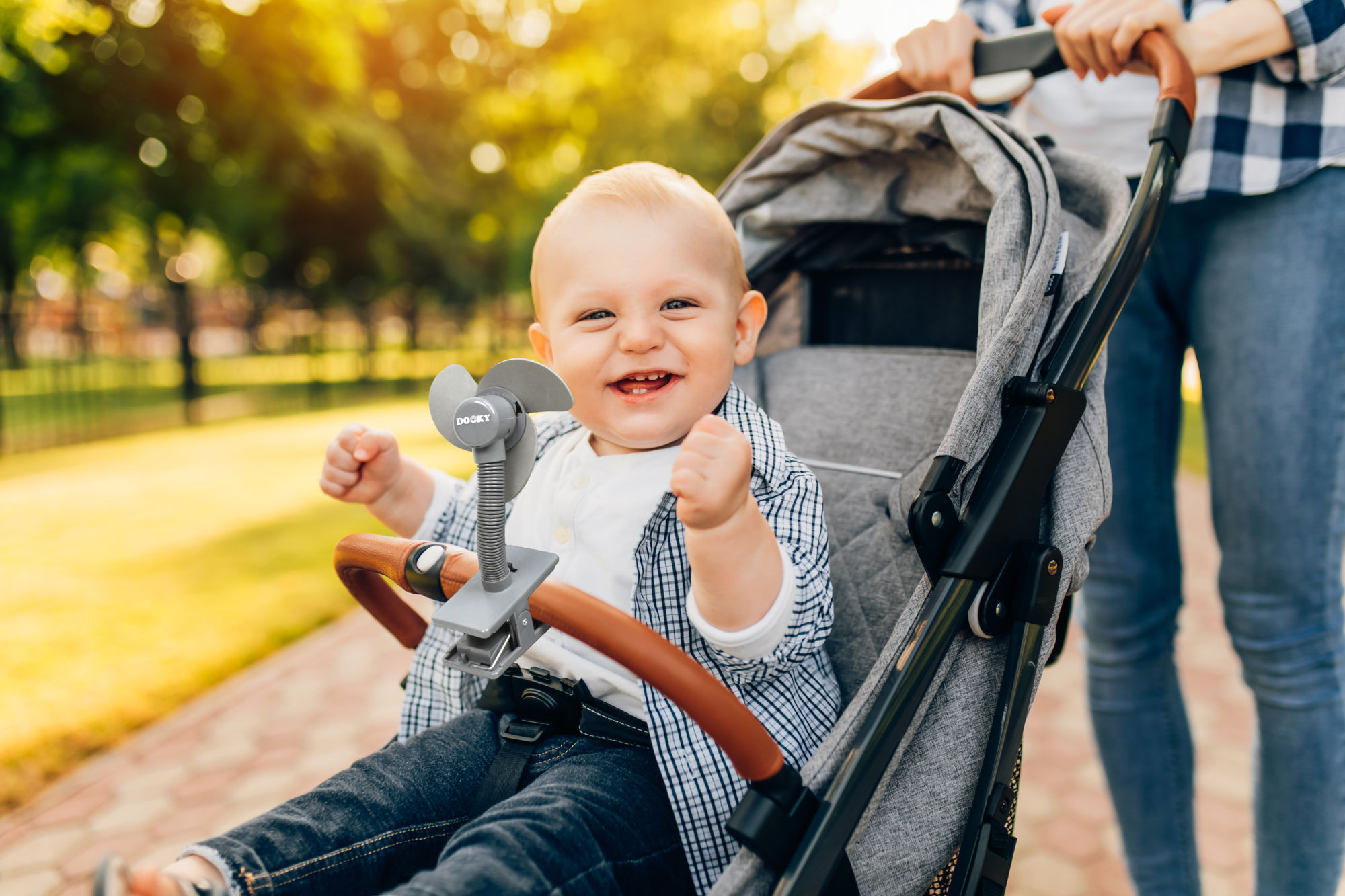 Happy smiling cute kid walking with mom outdoors on summer day